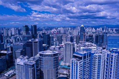 High angle view of modern buildings in city against sky