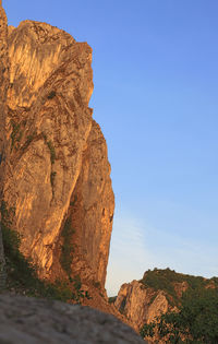 Low angle view of rock formations against sky