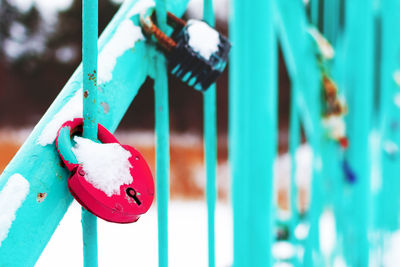 Close-up of red fence hanging on railing