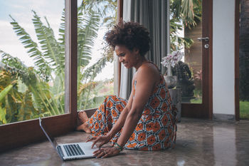 Young woman using laptop at home