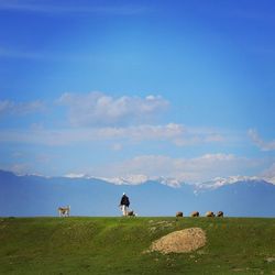 Scenic view of grassy field against cloudy sky