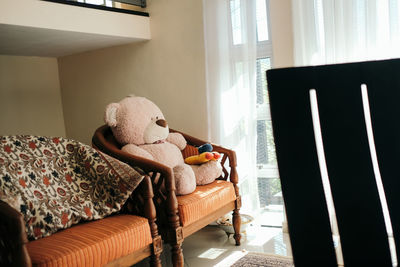 Rear view of woman sitting on sofa at home