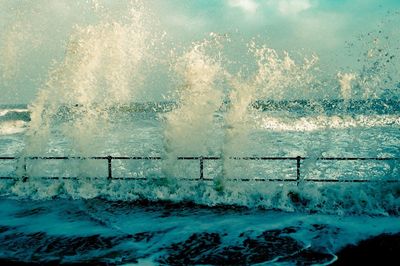 View of waves on sea against sky