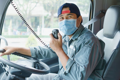 Portrait of man sitting in bus