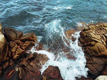 High angle view of rocks in sea