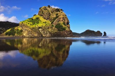 Scenic view of lake and rocks against sky