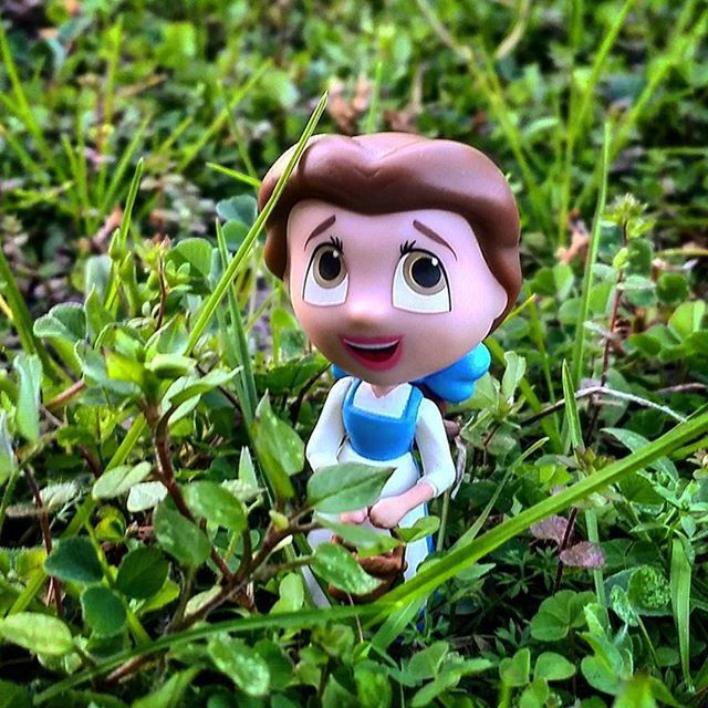 toy, green color, grass, human representation, childhood, looking at camera, close-up, portrait, creativity, field, focus on foreground, art, animal representation, high angle view, cute, anthropomorphic face, art and craft, figurine, humor