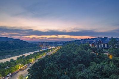 Panoramic view of buildings in city against sky at sunset