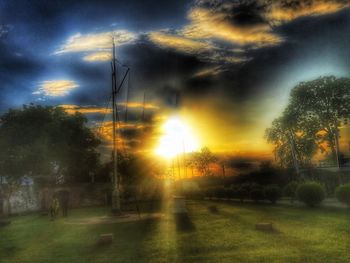 Scenic view of field against dramatic sky