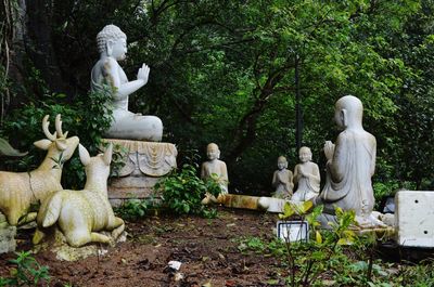 Statue of buddha against trees