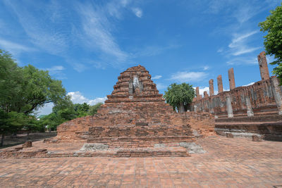 Ruins of temple against cloudy sky