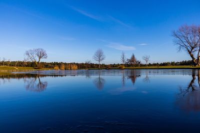 Scenic view of lake against blue sky