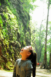 Boy looking at camera in forest