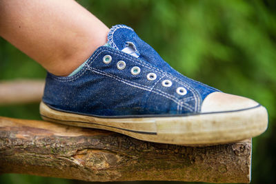 Low section of person wearing canvas shoes