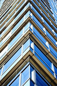 Low angle view of modern building against blue sky