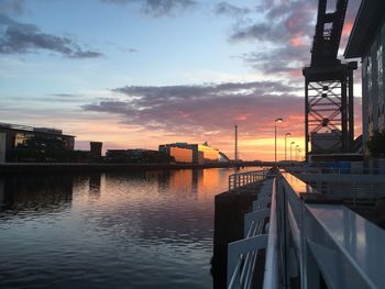 Boats moored at harbor during sunset