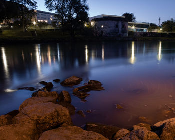 Scenic view of lake against sky at night