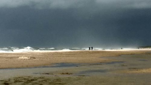 Man on beach against sky