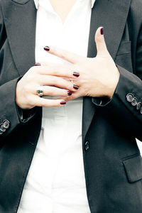 Midsection of woman holding ring in finger