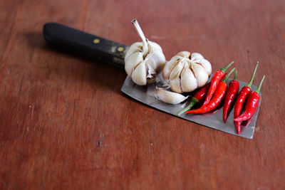 Close-up of red chili peppers on table