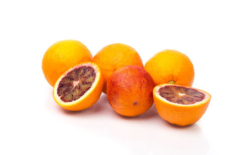 Close-up of orange fruit against white background