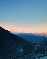 Scenic view of snowcapped mountains against clear sky during sunset