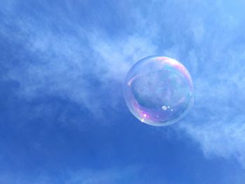 Low angle view of bubbles against sky