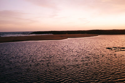 Scenic view of beach against sky during sunset