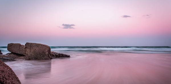 Scenic view of beach against sky during sunset