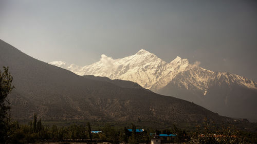 Scenic view of snowcapped mountains against sky