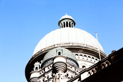 Low angle view of building against clear blue sky