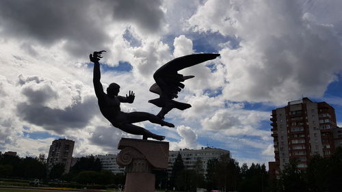 Low angle view of statue against sky in city