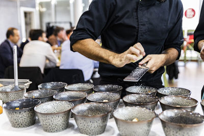 Midsection of man preparing food