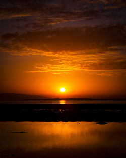 Scenic view of sea against romantic sky at sunset