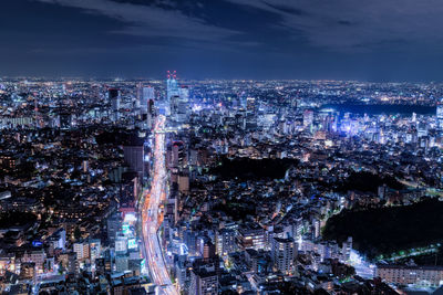 High angle view of city lit up at night