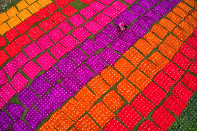 High angle view of woman arranging textile on land