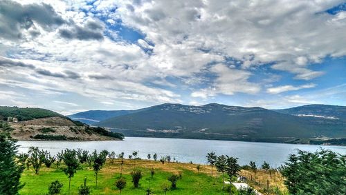 Scenic view of lake against cloudy sky