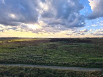 Scenic view of field against sky during sunset