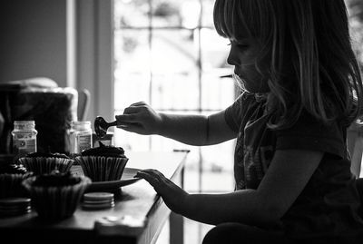 Close-up of girl preparing food at home