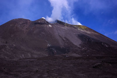 Scenic view of volcanic mountain against sky