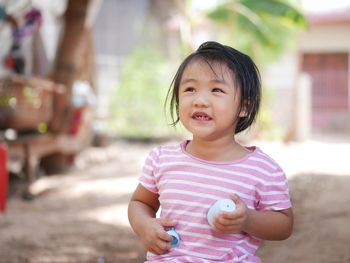 Portrait of cute girl standing outdoors