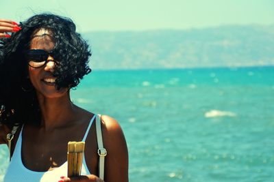 Portrait of woman wearing sunglasses at beach