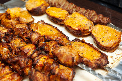 High angle view of meat on barbecue grill