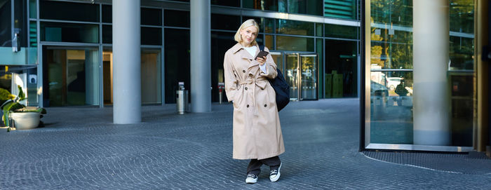 Rear view of woman standing in city