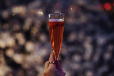 Cropped image of woman holding champagne glass