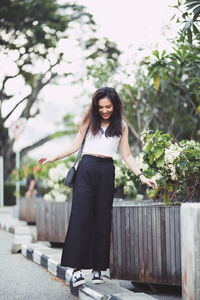 Portrait of a smiling young woman standing outdoors