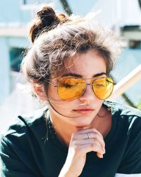 Close-up portrait of young woman wearing sunglasses