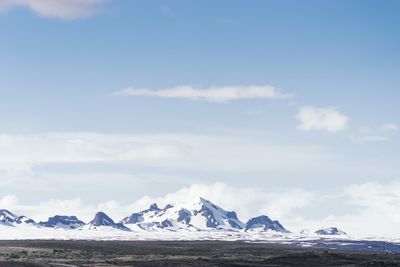 Scenic view of snow covered mountains against sky