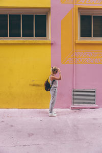 Full length of woman on window