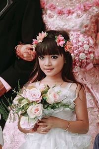 Portrait of woman with pink flowers